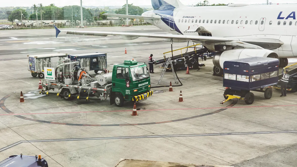 Cargo aircraft being loaded with palletized freight at night