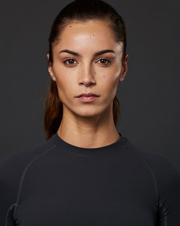 Olympic lifting coach Lena Brooks, high-contrast black-and-white portrait